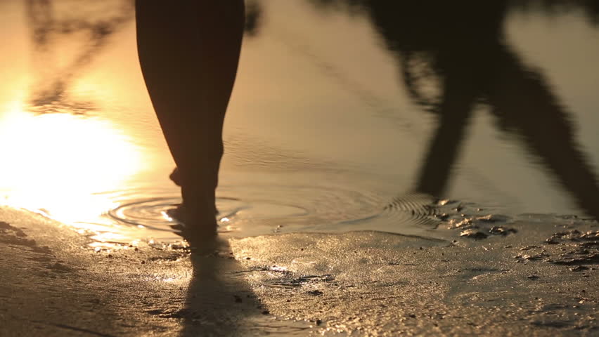 Close-up of female feet walking barefoot on sandy lake shore at sunset | Shutterstock HD Video #18360949