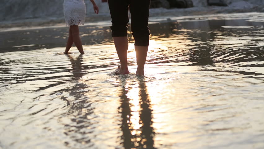 Couple walk along lake sand beach to the water | Shutterstock HD Video #18360979