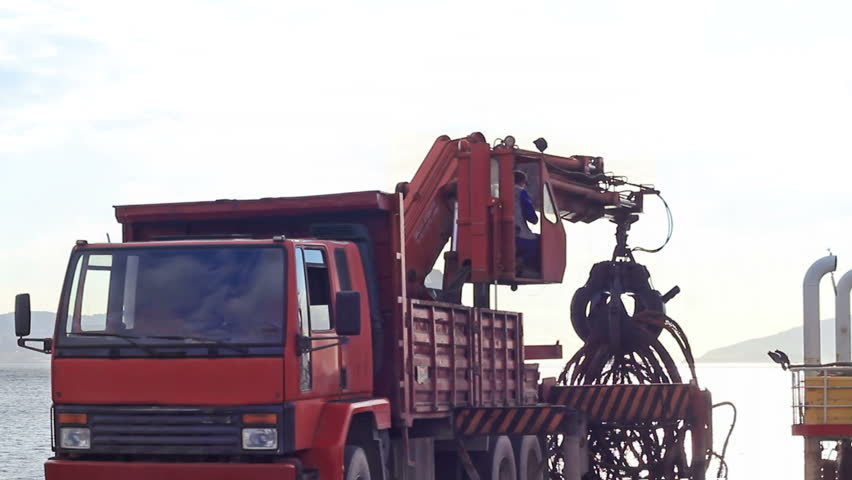 Truck crane lifting up scrap rebars 