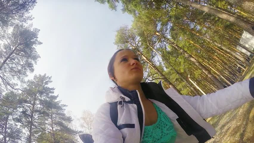 Young woman riding a bicycle in the park in slowmotion. 1920x1080