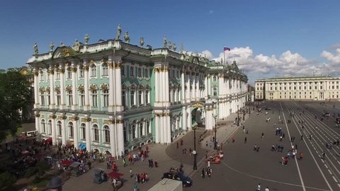 Palace Square from above aerial quadcopter flightover. Best St.Petersburg drone footage. Winter palace hermitage museum fasade. Alexander column with angel and cross. People walking, sunny day.