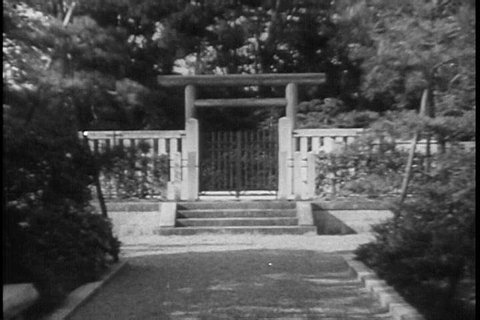 A Japanese fortress and temple in the 1940s with torii, traditional gate, and pagoda, customary tower and architecture, situated in the rural countryside. (1930s)