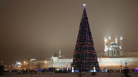 New Year's central Christmas tree near Kazan Kremlin with the view on Kul Sharif Mosque and Soyembika Tower. Stock Video