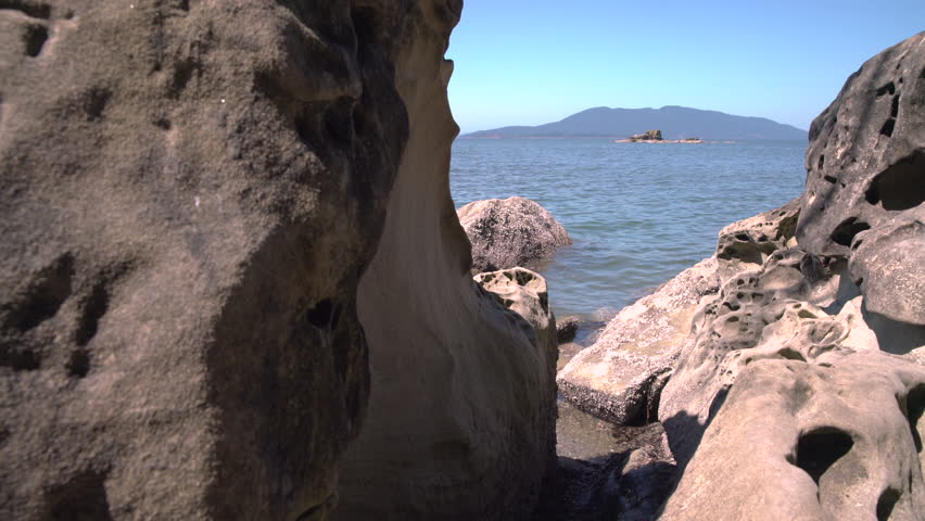 Larrabee State Park, Rock Formations, WashingtonÂ  4K, UHD. A dolly shot on the beach of Larrabee State Park past water worn rocks looking out into Samish Bay. 4K UHD.
