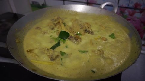 Malaysian dish Rendang Ayam or dry curry chicken is cooked in a wok