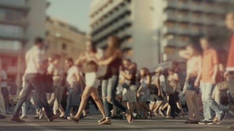 City crowd of pedestrians on summer day cross busy intersection,100fps slow motion gimbal stabilized tracking shot of an anonymous crowd of pedestrians.No logos or faces visible.Commercial shot.