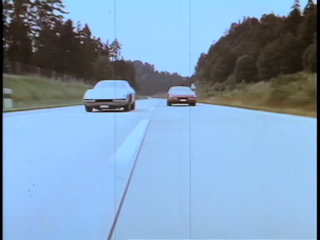 Two cars racing on empty road