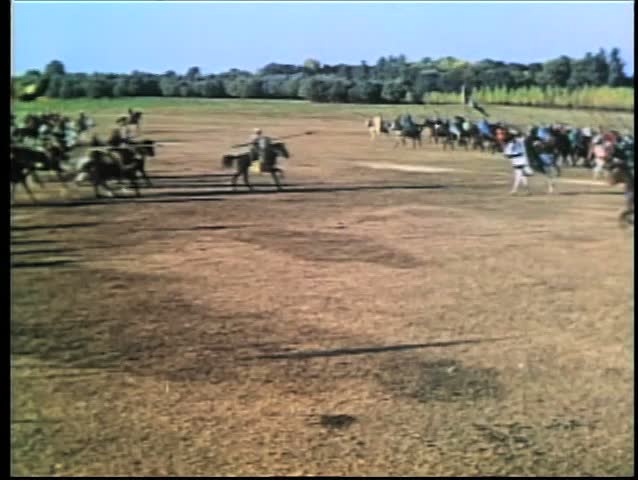 Wide shot medieval soldiers on horseback going into battle