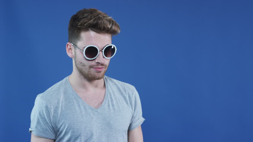 Young man wearing sunglasses looking at camera