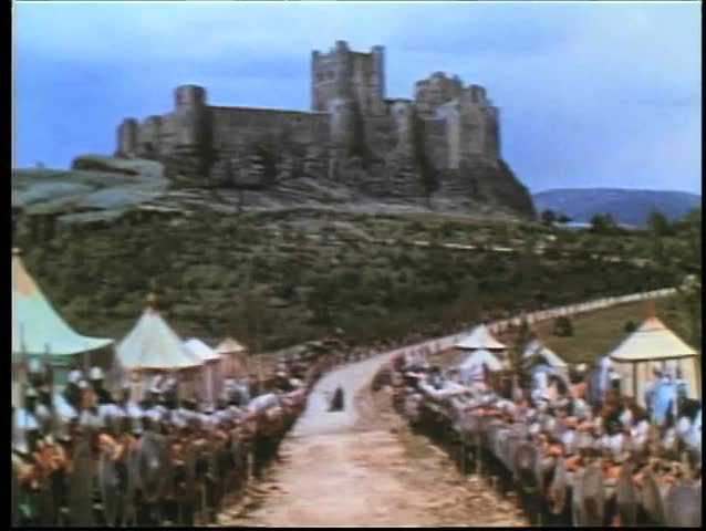 Medieval soldiers lined up on road leading to castle