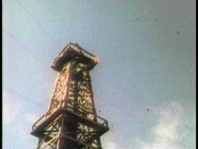 Low angle view oil gushing from derrick