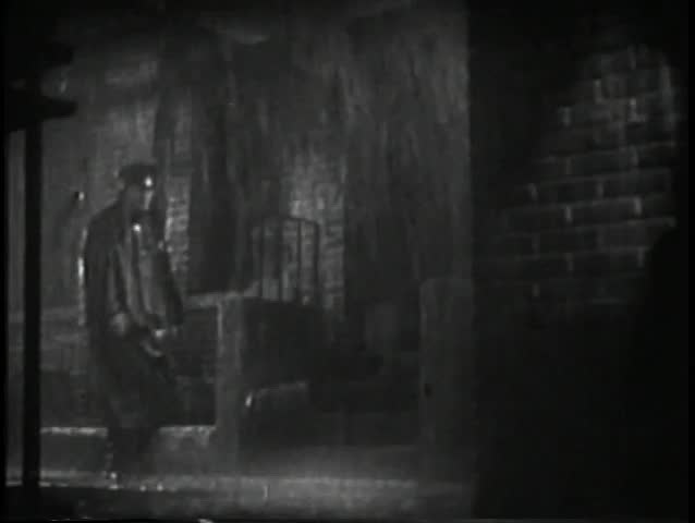 Wide shot policeman walking in the rain