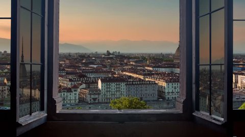 turin skyline time lapse from day to night seen from a window