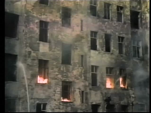 Historical reenactment of men extinguishing fire during World War II