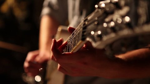 Man's hands playing guitar