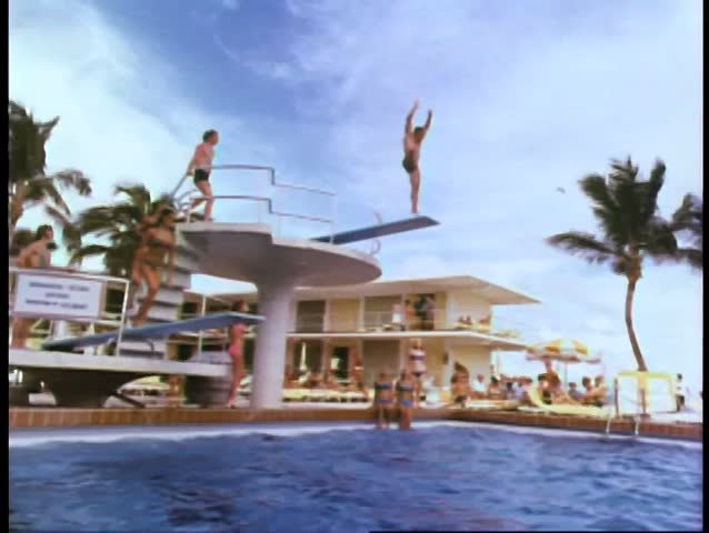 People diving into swimming pool