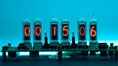Macro Time lapse of vintage Russian Nixie Tube digital clock counting backwards with blurry vibrations.