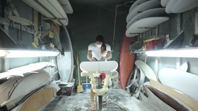 Surfboard shaping, Shaper using a foam sander to shape the nose of the surfboard. Skilled professional craftsman at work, small business millennial entrepreneur in America. - Powered by Shutterstock - Get 15% off with code: PIKWIZARD15