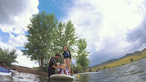 Denver, Colorado, USA-July 23, 2016. Recreational paddle boarding on small pond.
