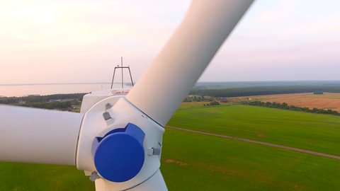 Aerial View. Beautiful windmill turbines sunset , wind energy turbines . Aerial drone shot. 4K 30fps