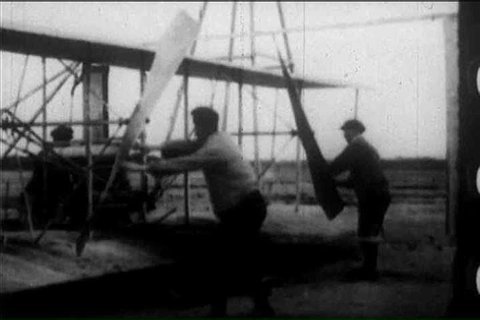 Footage of the first successful airplane flight by the Wright Brother in 1903, Kittyhawk, North Carolina, in an American broadcast about the history of aviation (1900s)