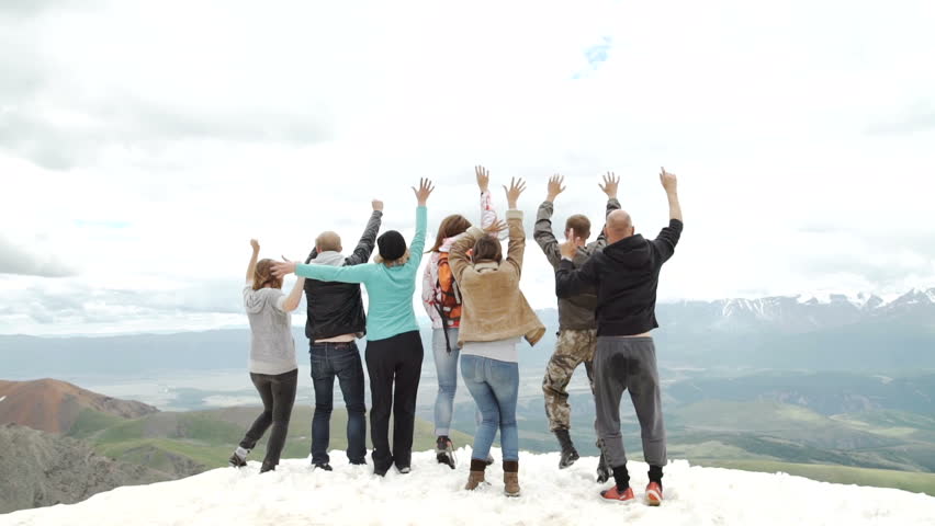 Silhouette of team on the mountain top. Sport and active life