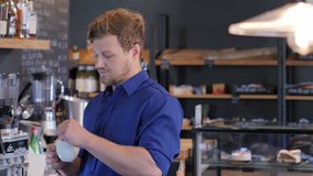 Barista tasting a new type of coffee in his coffee shop.