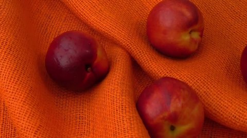 Peach nectarine isolated on orange background 
