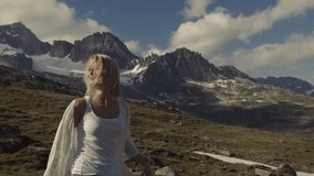 A girl is walking in the beautiful Alps, the video is shot under unusual angle. Slow motion. Nature beauty, just do it