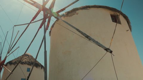 A cinematic POV shot featuring traditional windmills in the cycladic island of Mykonos Greece