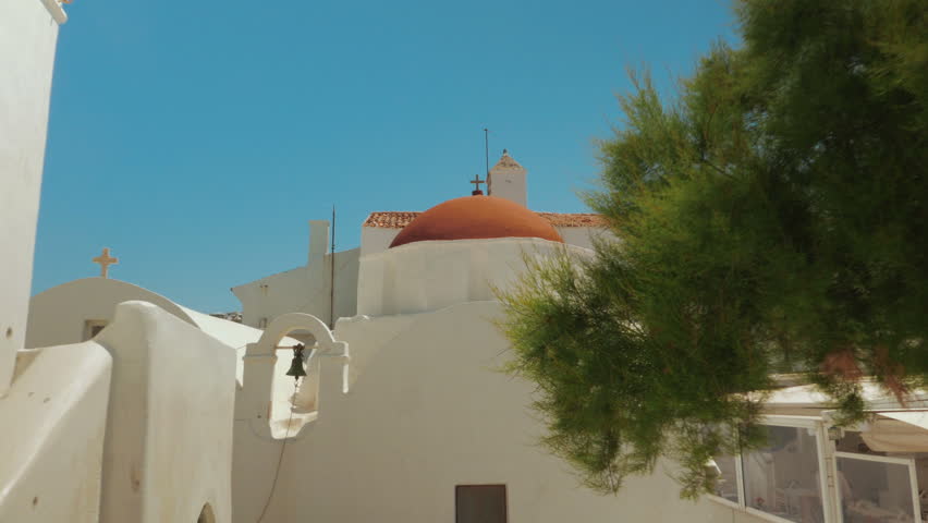 A POV walk towards a quaint cycladic church in the island of Mykonos Greece