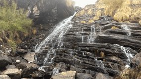 Water flowing falling through rocks in fog mountain river. Waterfall Himalayas Nepal nature hd video background.