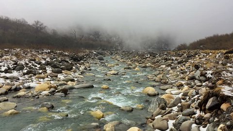 Mountain river flowing in Himalayas Nepal. Water falling through rocks. Snow fog nature travel background hd video.