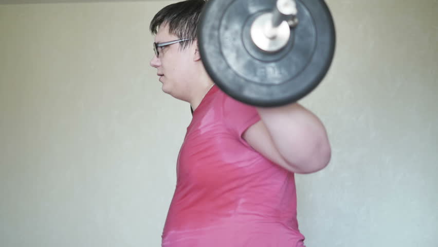 Tired man with overweight training with a barbell