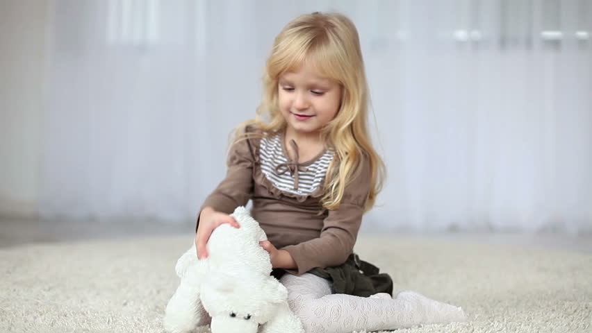 Child playing with a teddy bear