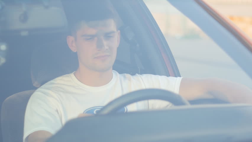 Portrait of a young man behing the wheel, slow-motion | Shutterstock HD Video #18462754