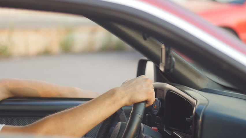 portrait of a young man behing the wheel, slow-motion