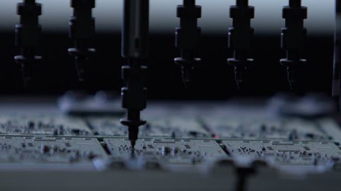 Robotic production of printed Circut Board. Producing Printed Circut Board. Electronics contract manufacturing. Manufacture of electronic chips. High-tech manufacturing.