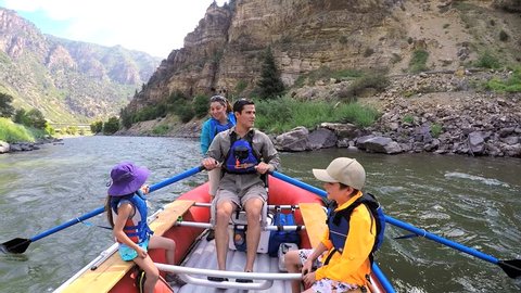 Happy American Caucasian family rafting on Colorado River on vacation outdoor