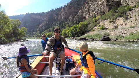 American Caucasian family rafting together on Colorado River on holiday outdoor