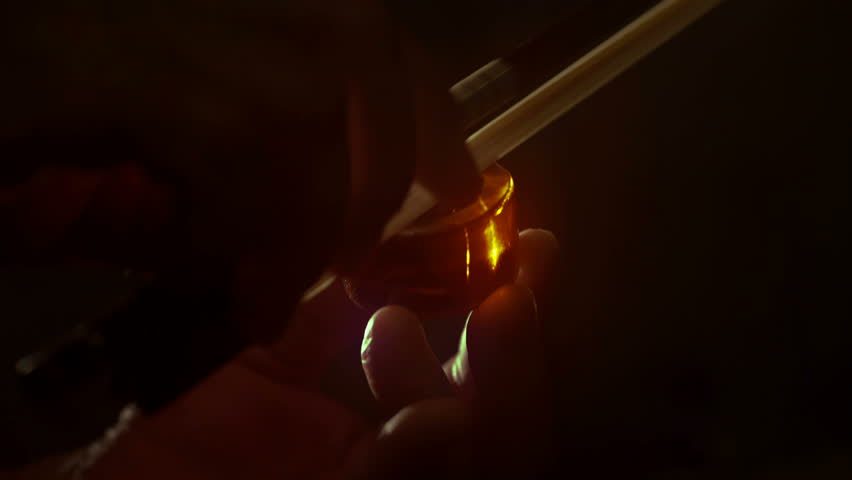 Violin bow (fiddlestick) rosin hands isolated. Dramatic back lighting, 4K, UHD, 24 fps | Shutterstock HD Video #18467704
