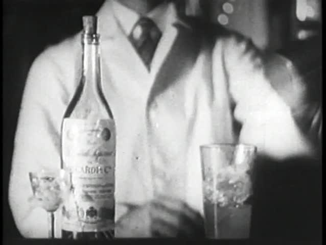 Bartender mixing drink in cocktail shaker