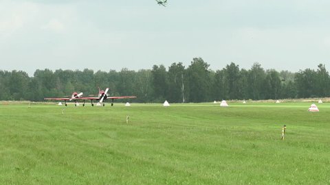 Russia, Novosibirsk, July 31, 2016: The Yakovlev Yak-52. Two Yak-52 preparing for takeoff. Yak-52 on the runway. Two Yak-52 pick up speed and take off. Demonstration team in Yak-52.
