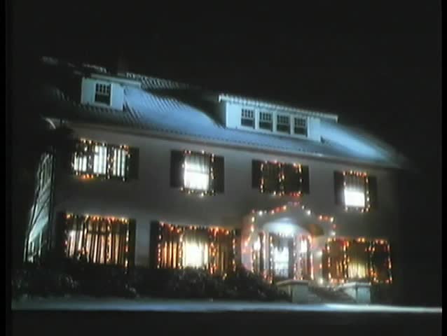 Establishing shot of house decorated with Christmas lights