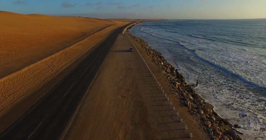Aerial sky view from drone of Namibian Atlantic coastline, sand dunes, sunny horizon and landscape with ocean background south of Swakopmund off highway towards Walvis Bay in Namibia