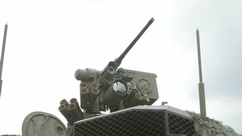 Close up view of the turret, armaments and gun of an operational military armored tank vehicle.