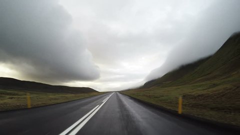 Driving pov stormy clouds misty mountain canyon peaks Iceland 4k