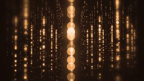 Lights gold bokeh background. Elegant gold abstract. Glittering particles on a black background. loop able abstract background circles.