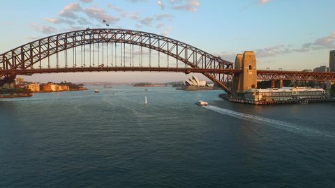 Aerial views of Sydney Harbour Bridge, from helicopter featuring Sydney CBD, Sydney Ferries (ferry), in Port Jackson on the Parramatta River.