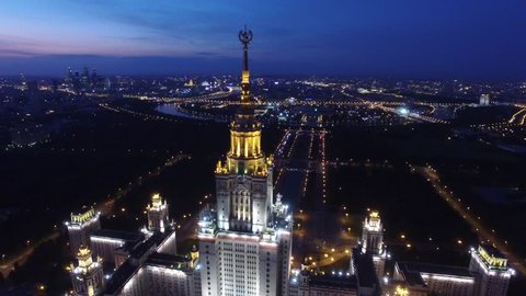 Beautiful evening shot of MSU Moscow State University. Unique night Aerial drone footage. Flight near spire and star, high altitude. Illumination. Stalin skyscraper.